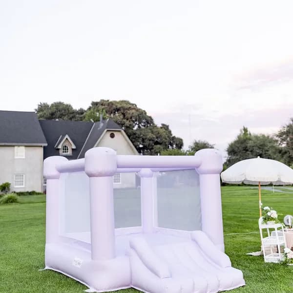Lilac bounce house rental on lawn at Las Vegas party